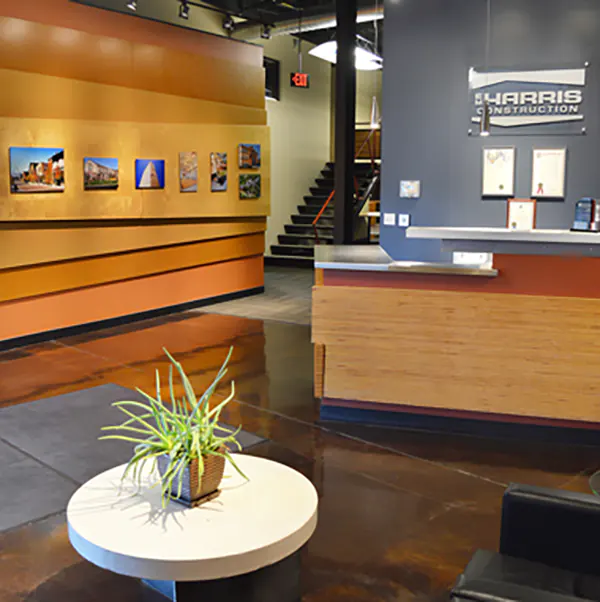 A table and desk in the lobby of E.M. Harris Construction